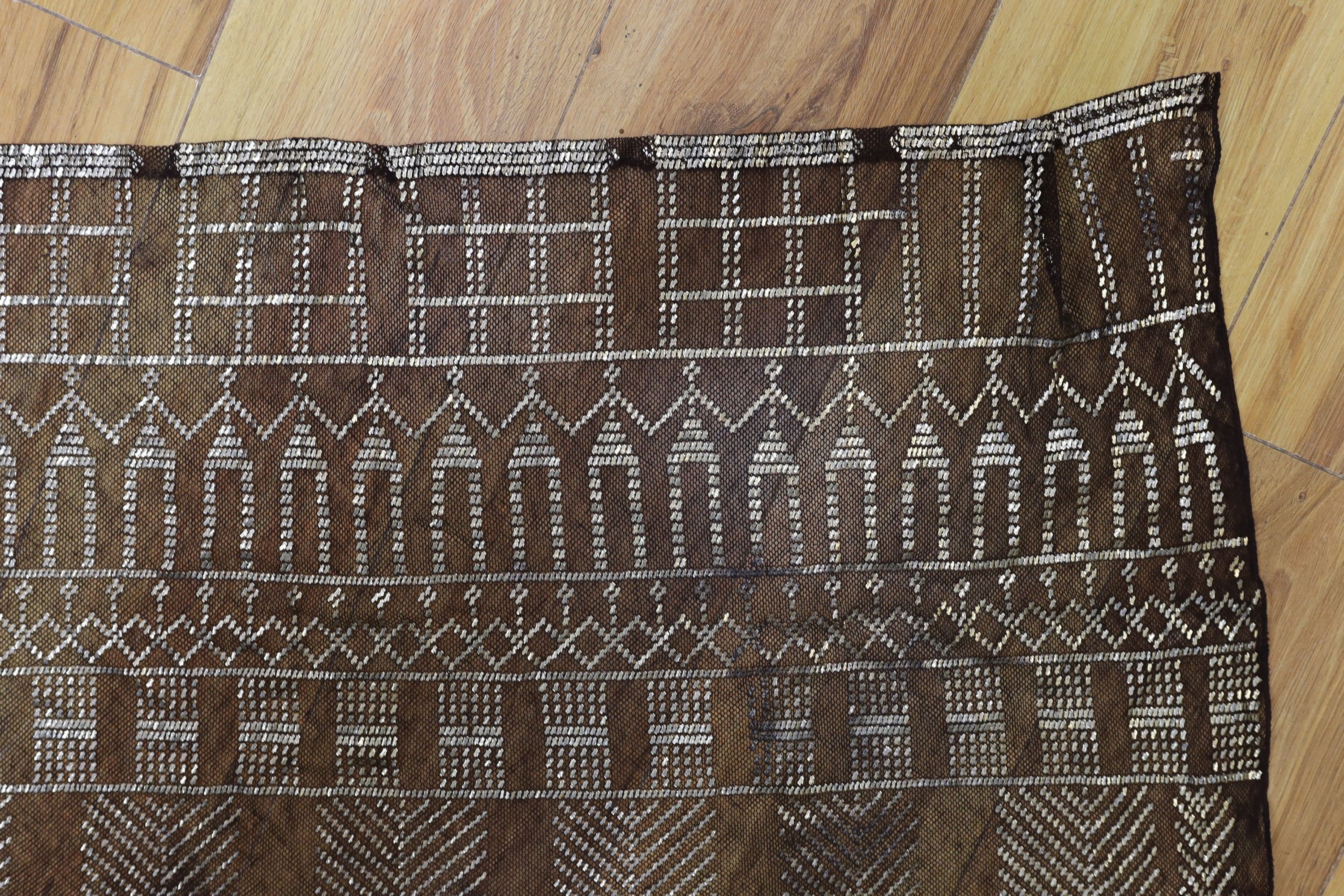 A dress made from a metal and black net Egyptian shawl; a similar shawl and a piece of shawl